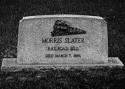 A gravestone marking the burial site of Morris Slater, also known as Railroad Bill, with an engraving of a train and the date of death, March 7, 1896.