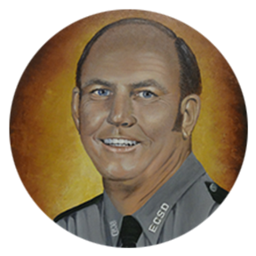 A portrait of a smiling male figure in a gray uniform, set against a warm orange background. The figure has short hair and is depicted with blue eyes.