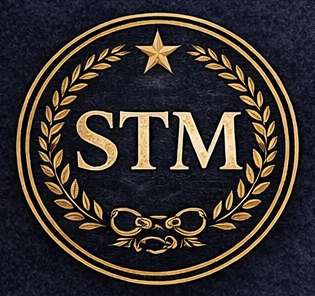 A circular emblem featuring the letters 'STM' in a bold font, surrounded by an olive branch design and a star at the top, set against a textured dark background.