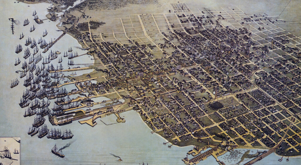 Aerial view of a historical city map featuring numerous buildings, streets, and a harbor filled with ships.