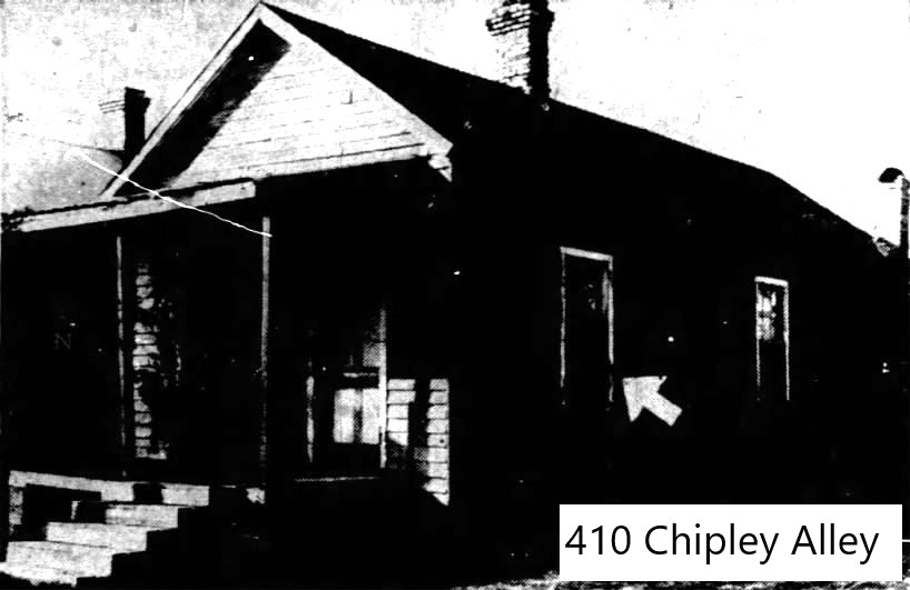 Black and white image of a house located at 410 Chipley Alley, featuring a porch and a visible arrow sign.