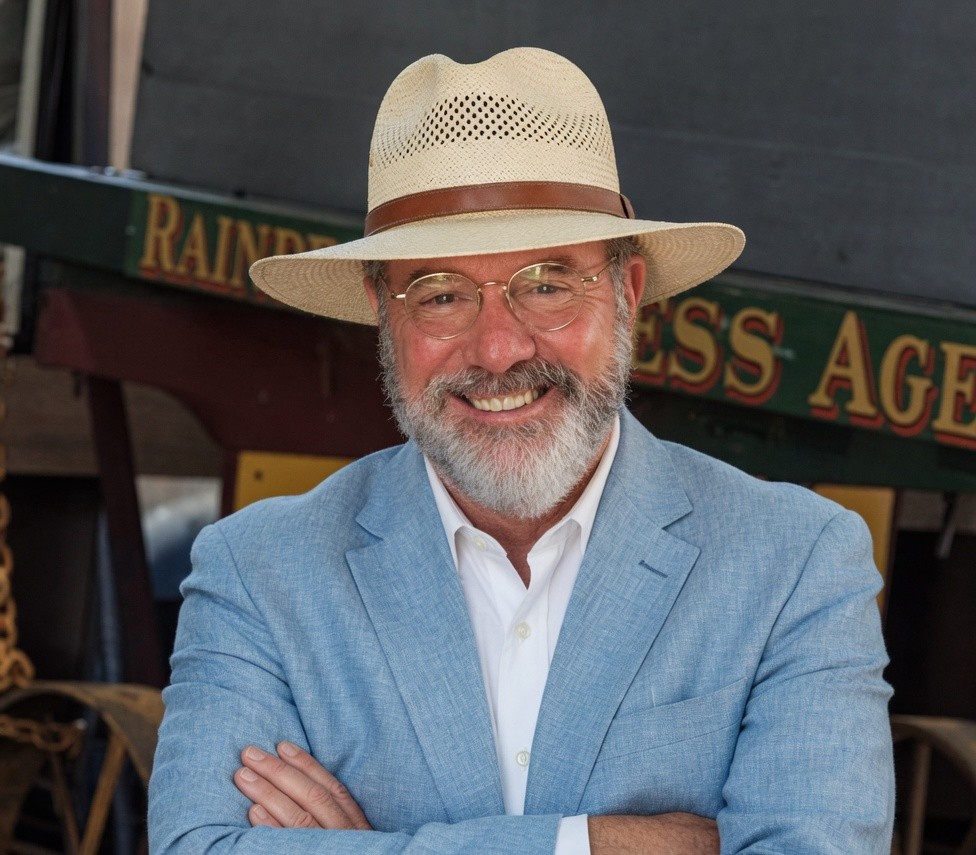 Michael Simmons in a blue blazer and straw hat